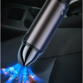 A sleek, metallic gray handheld car vacuum with a glossy finish and blue led lights illuminating the suction nozzle as it cleans debris from a car seat.