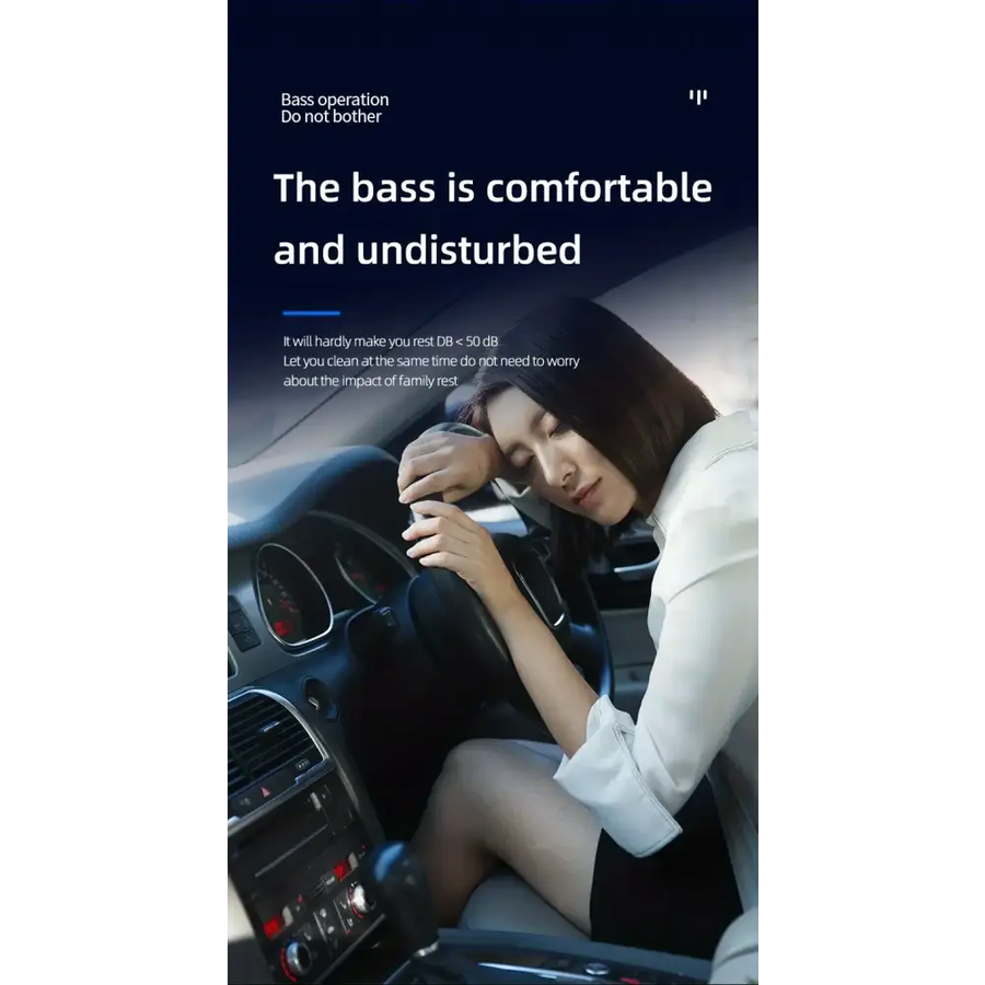 A woman in a white blouse and black skirt rests her head on the steering wheel of a car, appearing tired or relaxed.