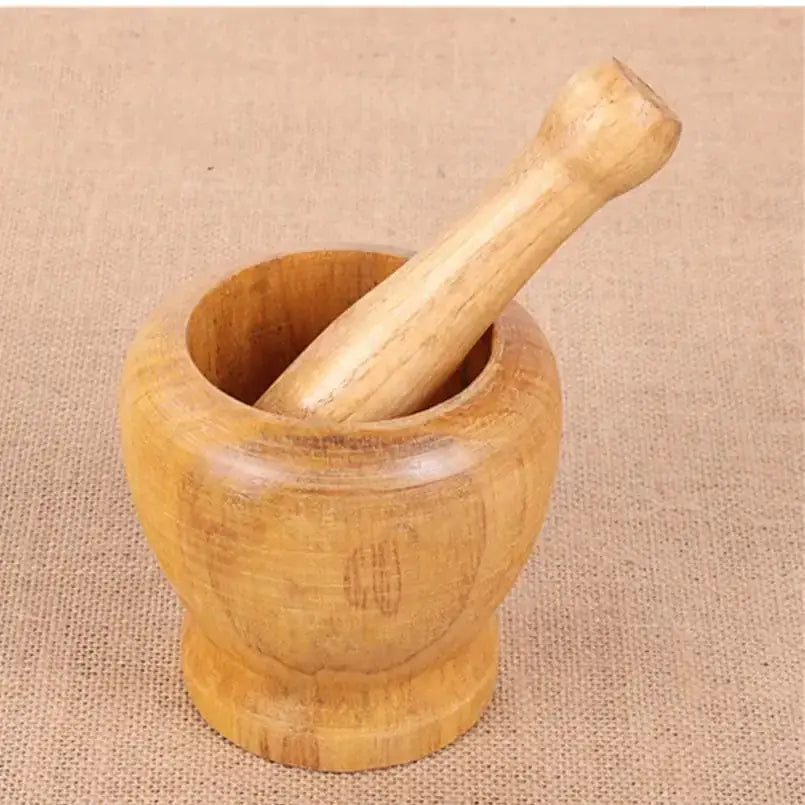 Light brown wooden mortar and pestle set with a smooth, rounded bowl and matching handle.