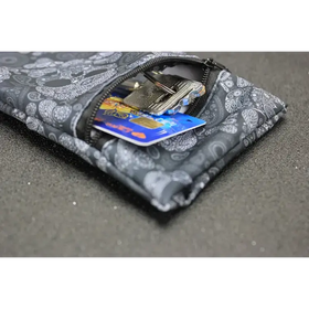 Black and gray skull-patterned fabric key pouch with zipper closure.