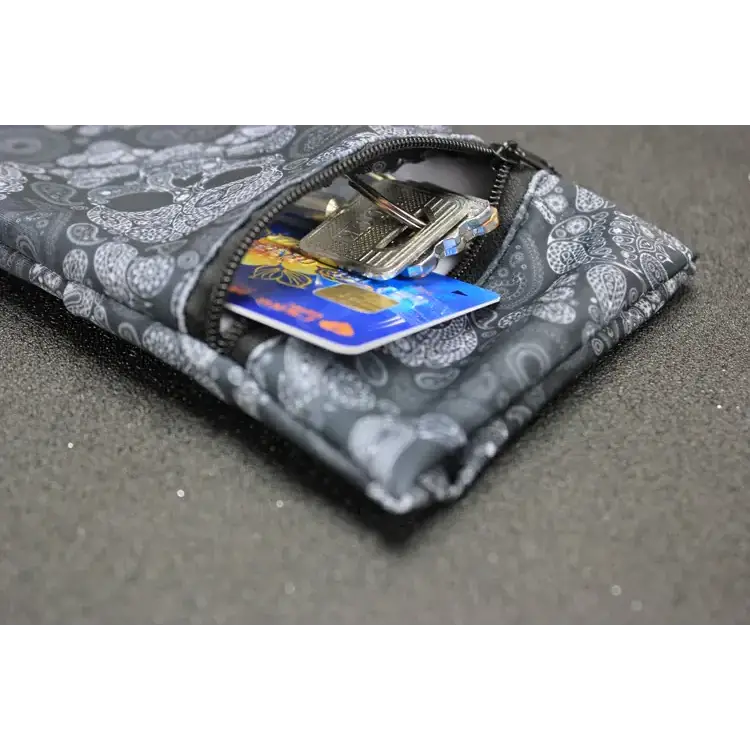Black and gray skull-patterned fabric key pouch with zipper closure.