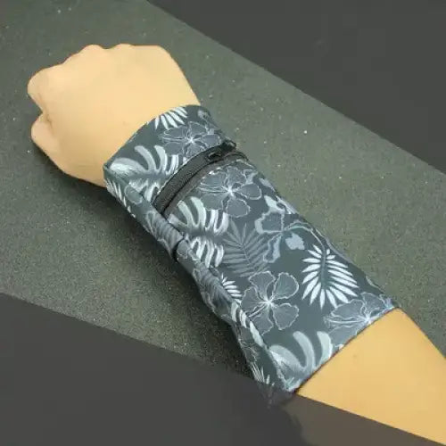 Gray floral-patterned wristband with black zipper detail.