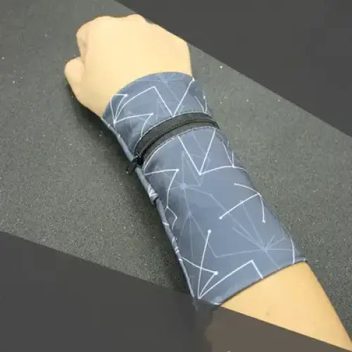 Gray geometric-patterned wristband with black zipper.