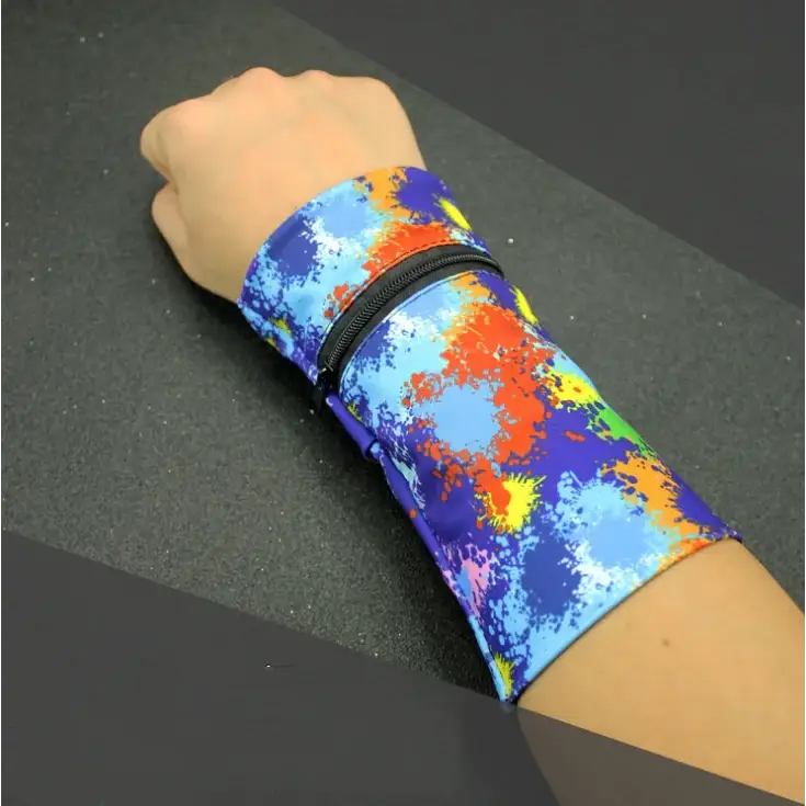 A vibrant, multicolored wristband with a splatter paint design in shades of blue, orange, yellow, and green, featuring a black zipper closure.
