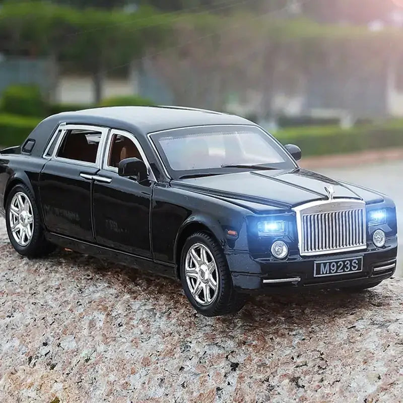 Black die-cast model of a rolls-royce phantom with chrome grille and wheels.