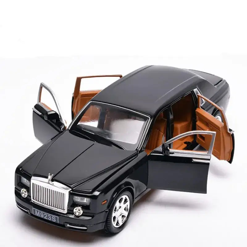 Black diecast model of a rolls-royce phantom with tan interior and chrome detailing.