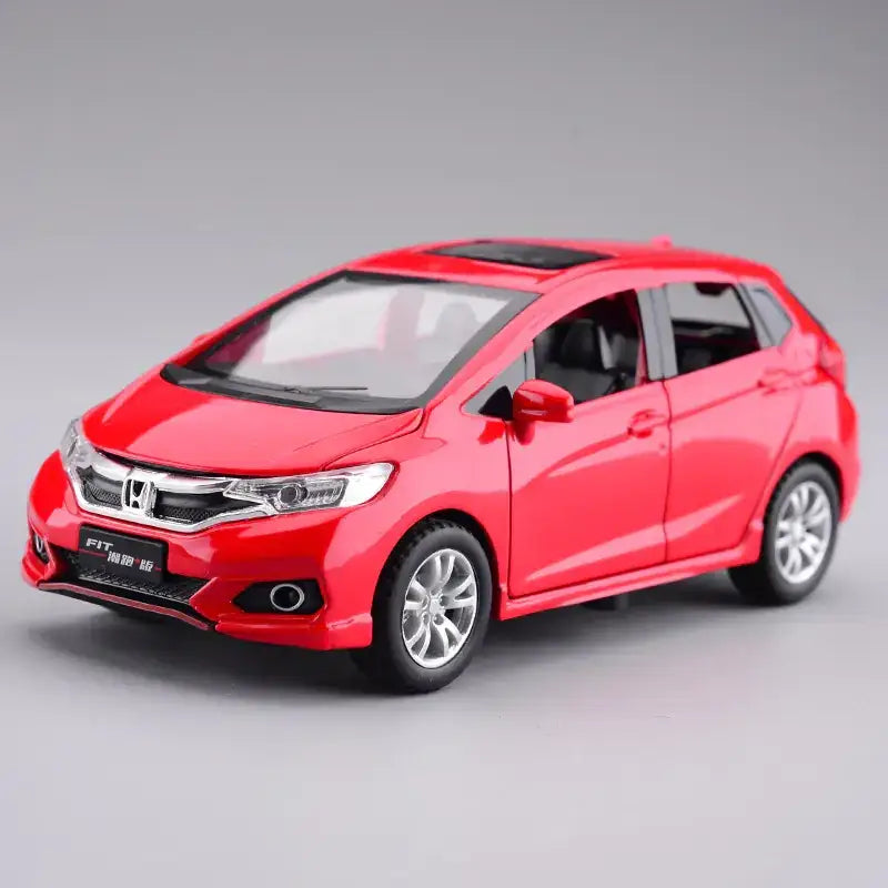 Red metallic honda fit die-cast model car with silver alloy wheels and black roof.