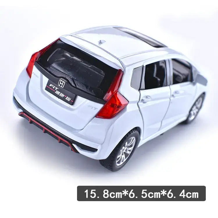 White die-cast honda fit model car with red taillights and black trim.