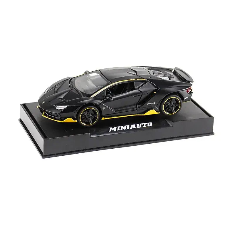 Black and yellow lamborghini centenario diecast model car on a black display base.