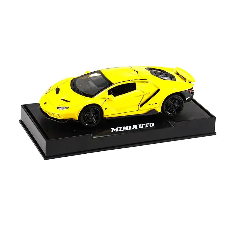 Bright yellow die-cast lamborghini centenario model car on a black display base.