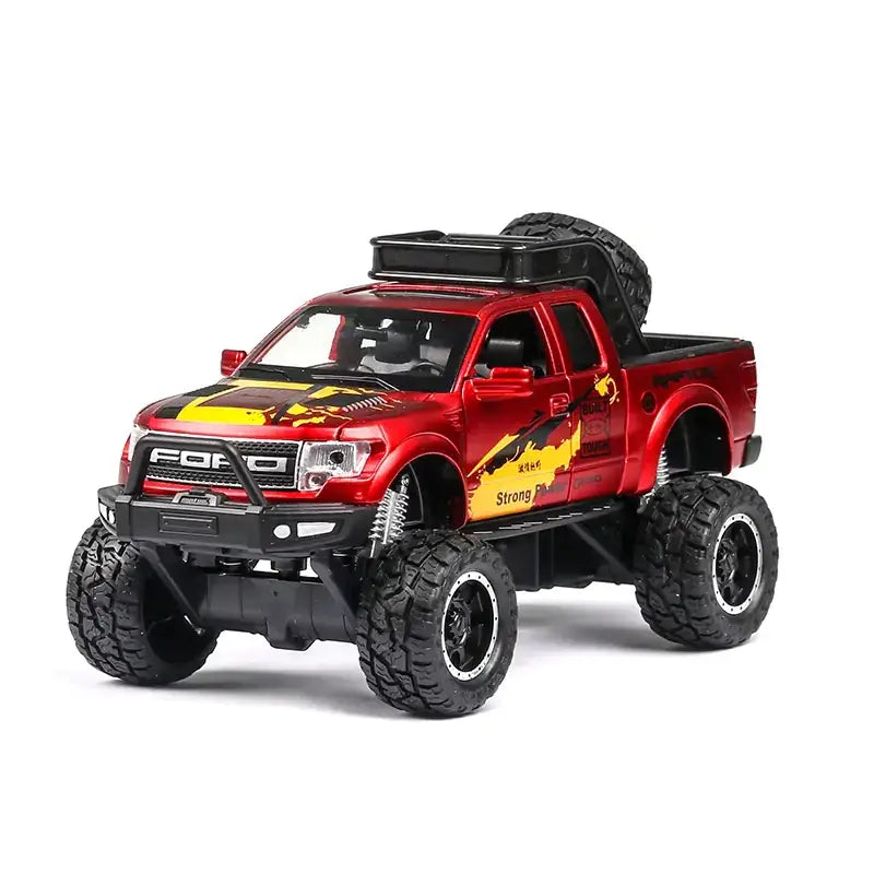 Red and yellow flame-themed die-cast ford f-150 pickup truck model with black off-road tires, chrome accents, and a spare tire mounted on the roof.
