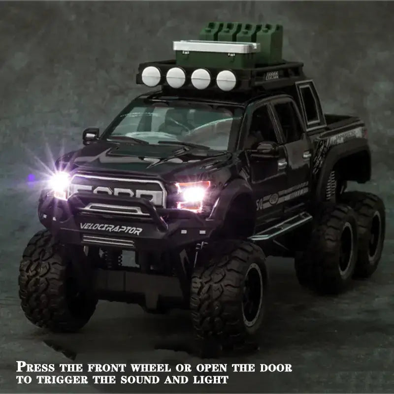 Black die-cast toy pickup truck with oversized tires, roof-mounted lights and a green cooler.