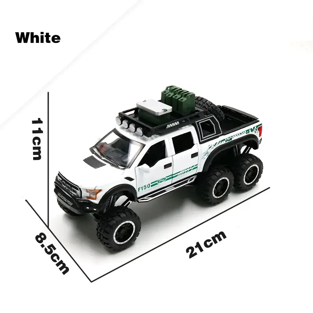 White die-cast ford f-150 pickup truck model with green and black detailing, oversized tires, roof rack, and spare tire.