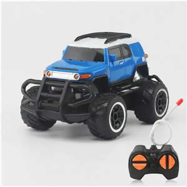 Blue and white remote-controlled monster truck with black rugged tires, a front bumper guard, and orange-accented control buttons on its matching controller.