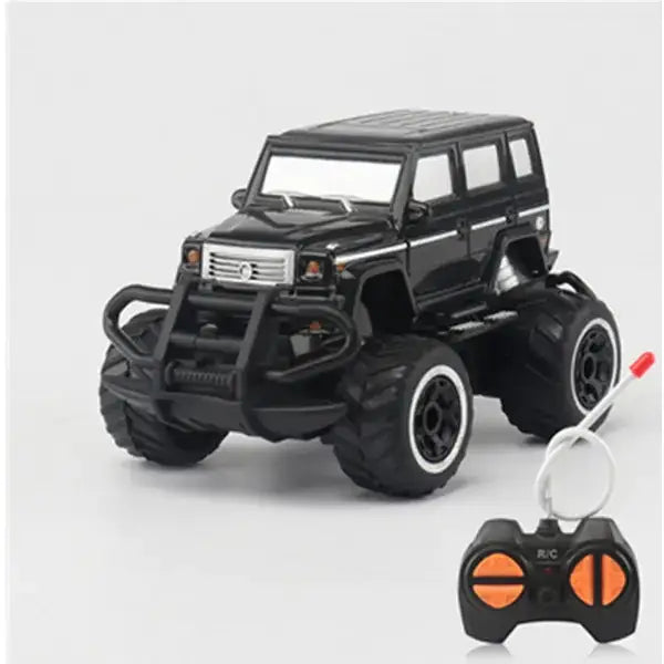 Black remote-controlled monster truck with oversized tires and a rugged front bumper.