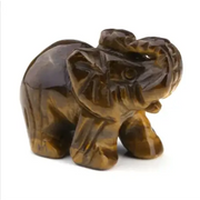 A polished brown tiger’s eye elephant figurine with intricate carved details.