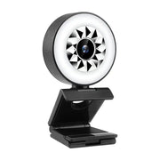 Black webcam with a circular ring light featuring a geometric starburst pattern around the lens.