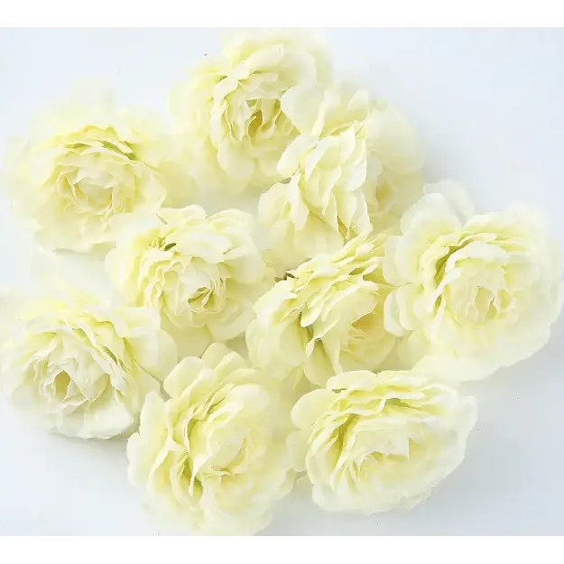A cluster of delicate, pale yellow artificial roses with soft, layered petals.