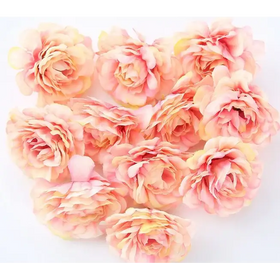 A cluster of delicate, peach and soft yellow artificial peonies with layered petals.