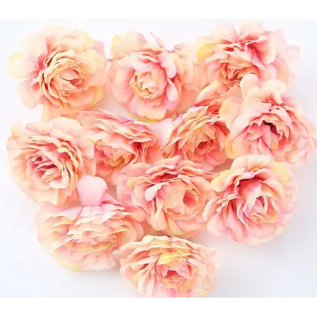 A cluster of delicate, peach and soft yellow artificial peonies with layered petals.