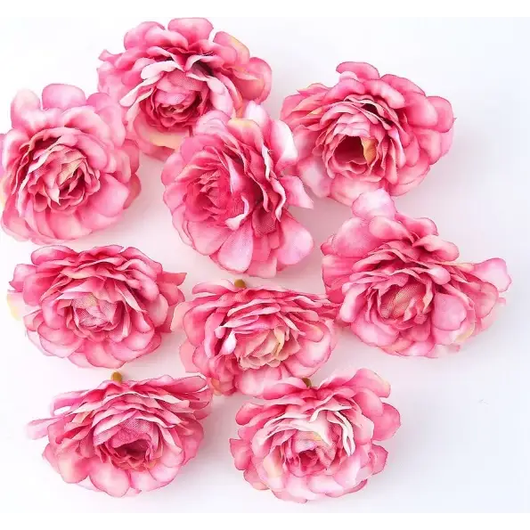 Pink artificial roses with layered petals and subtle white accents.