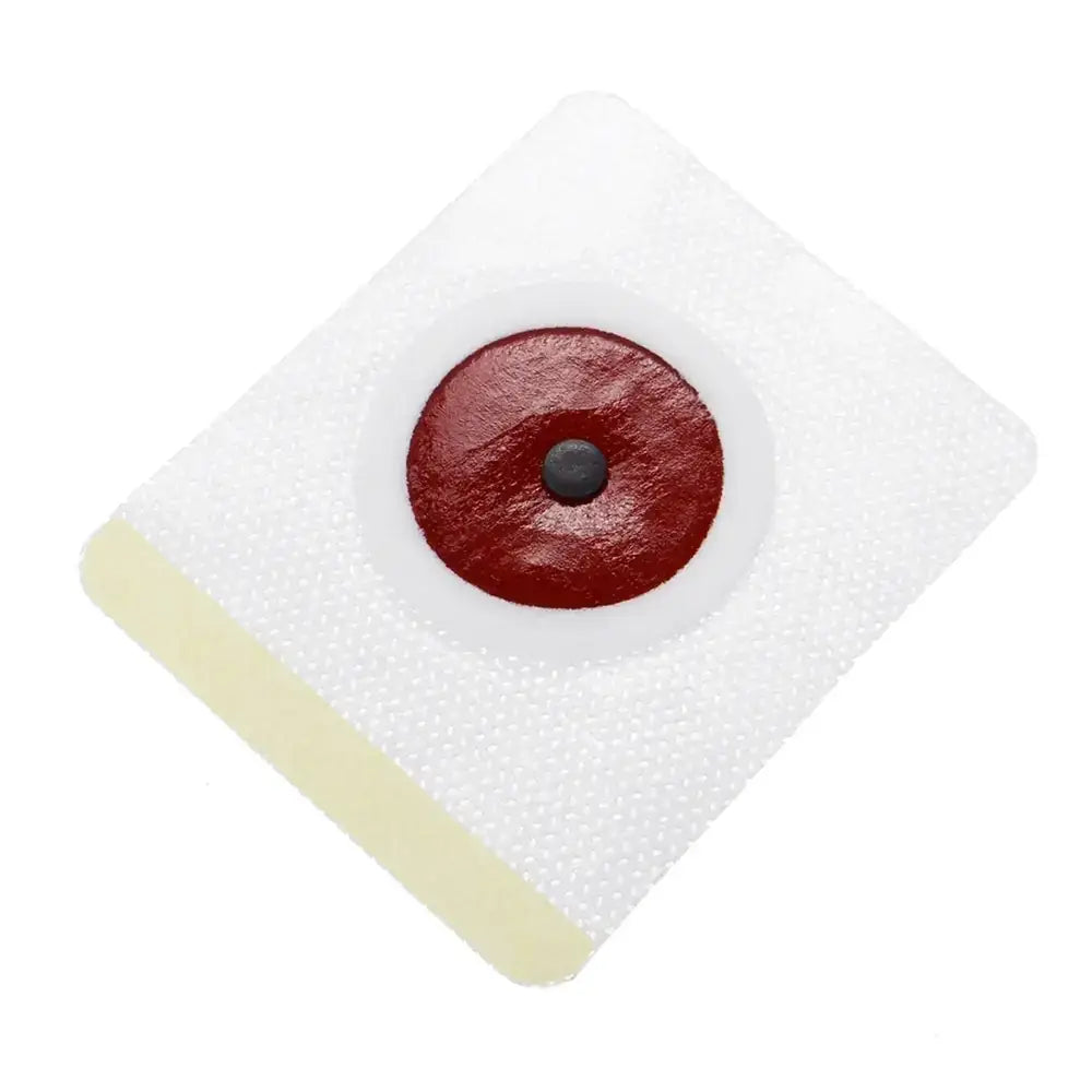 White adhesive wound dressing with a central red circular pad and a small black dot in the middle.
