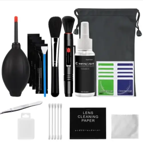 Black lens cleaning kit with assorted brushes, blower, spray bottle, and microfiber cloths