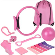 Pink pilates ring with black accents and a matching pink drawstring bag.