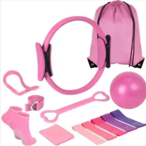 Pink pilates ring with black accents and a matching pink drawstring bag.