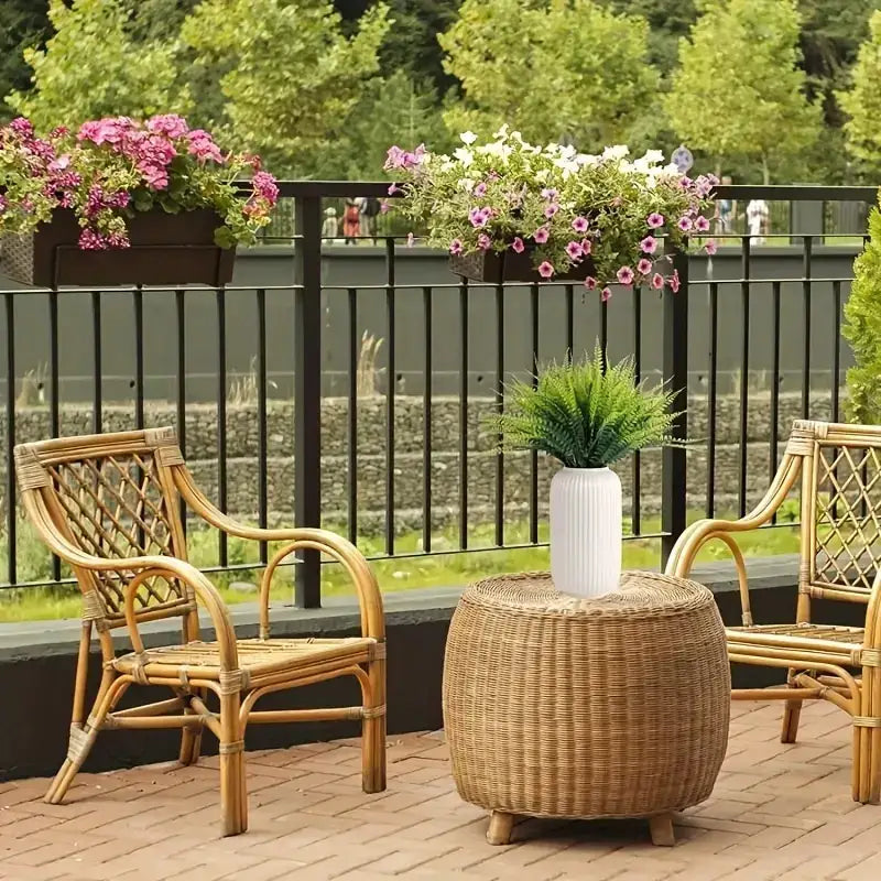 White ribbed ceramic vase holding a green artificial fern