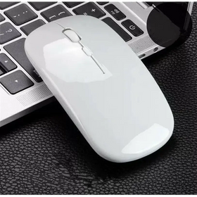 A sleek white wireless mouse with a glossy finish and minimalist design, resting beside a laptop.