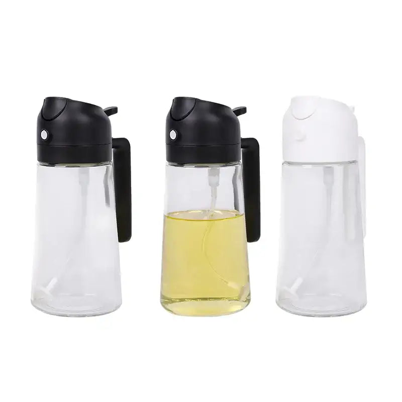Three clear glass oil dispensers with black and white pump tops, one filled with yellow liquid.