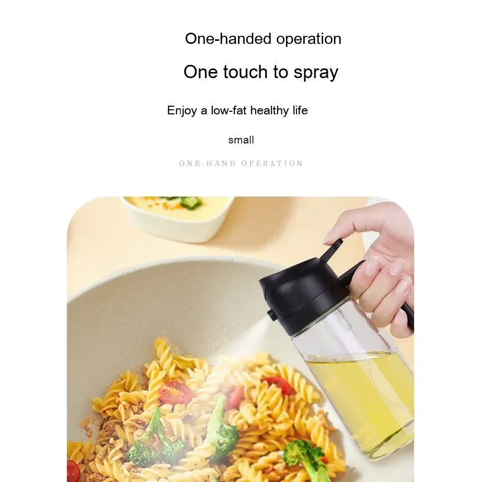 Clear glass oil dispenser with a black spray nozzle and handle, designed for one-handed operation.