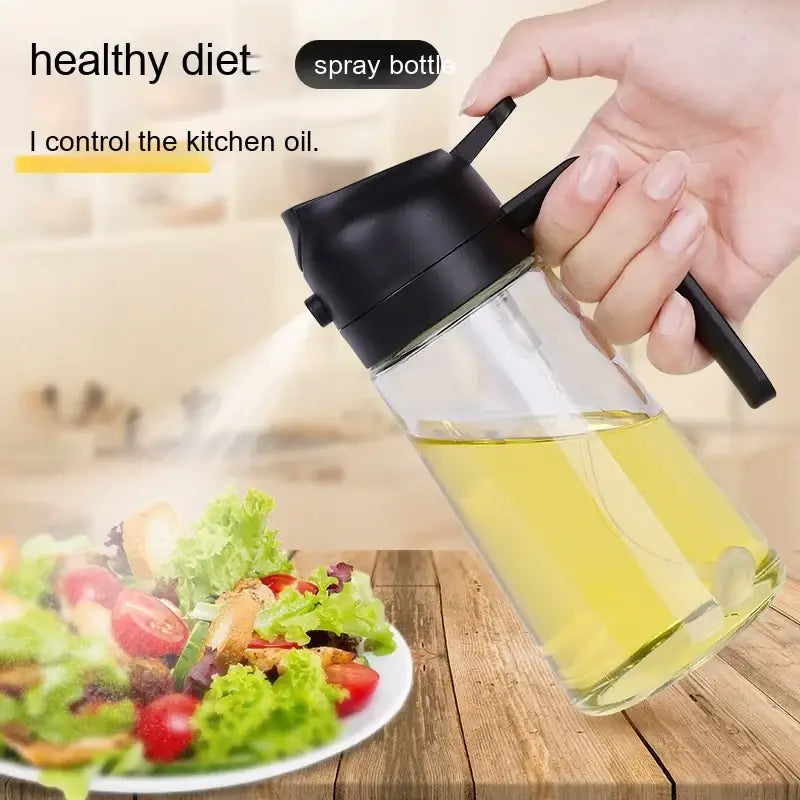 Clear glass spray bottle with a black plastic top and handle, filled with golden-yellow oil.