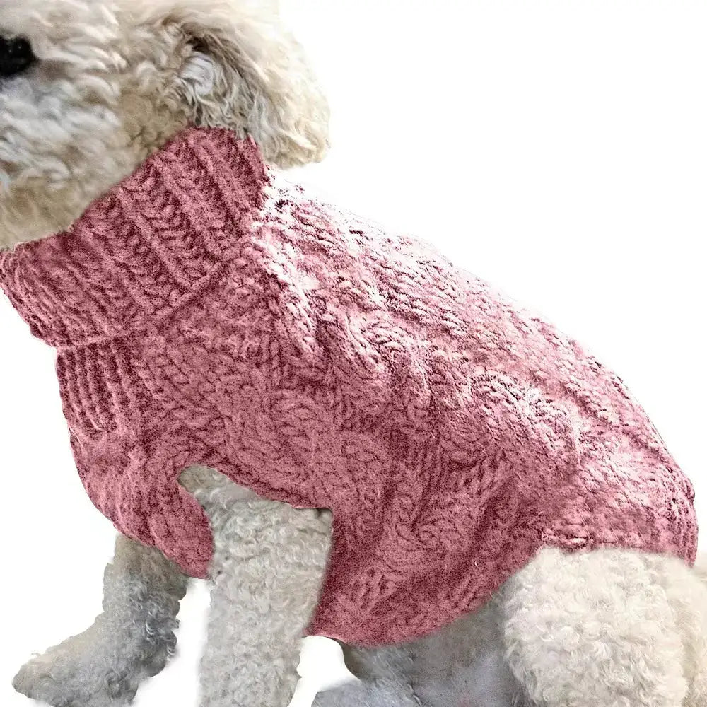A cozy pink cable-knit sweater designed for dogs, featuring a high collar and textured knit pattern.