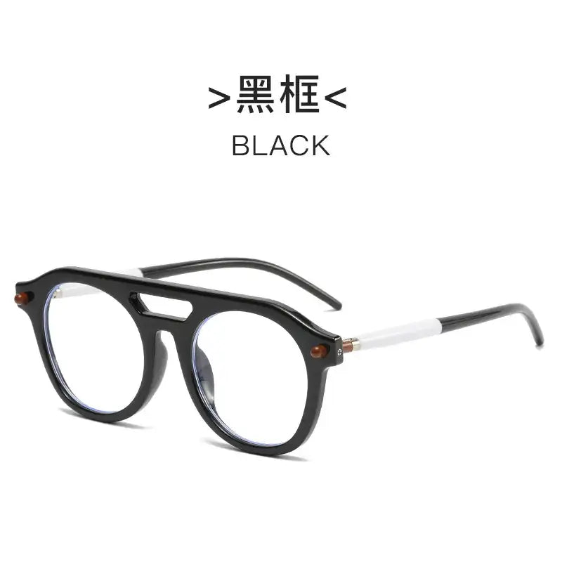 Black framed glasses with a bold, round design and white temple tips.