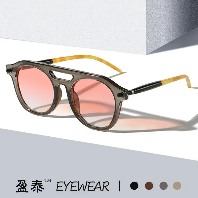 These are stylish, gradient pink-tinted sunglasses with a dark gray frame and tortoiseshell-patterned temple tips.