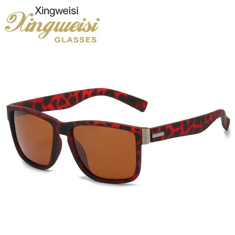 Red and black leopard-print framed sunglasses with brown gradient lenses.