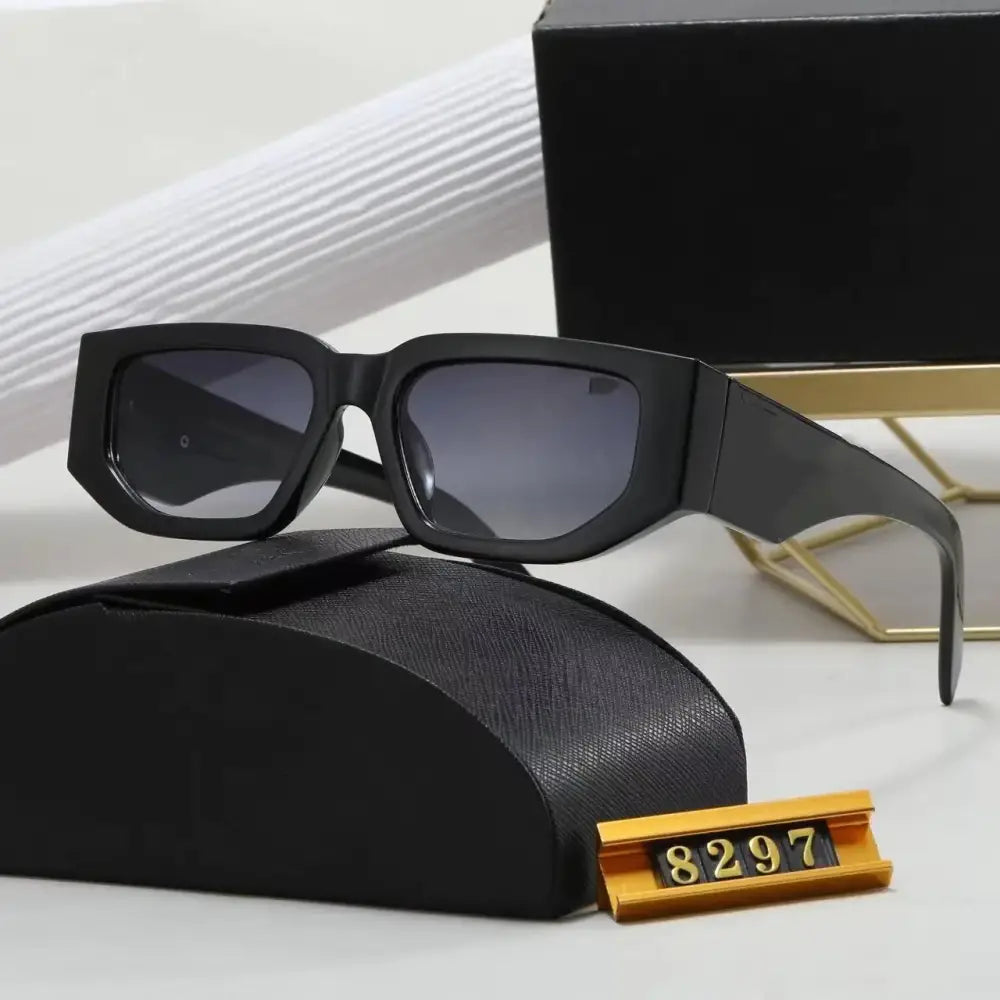Black rectangular sunglasses with gradient gray lenses and a sleek, modern design.