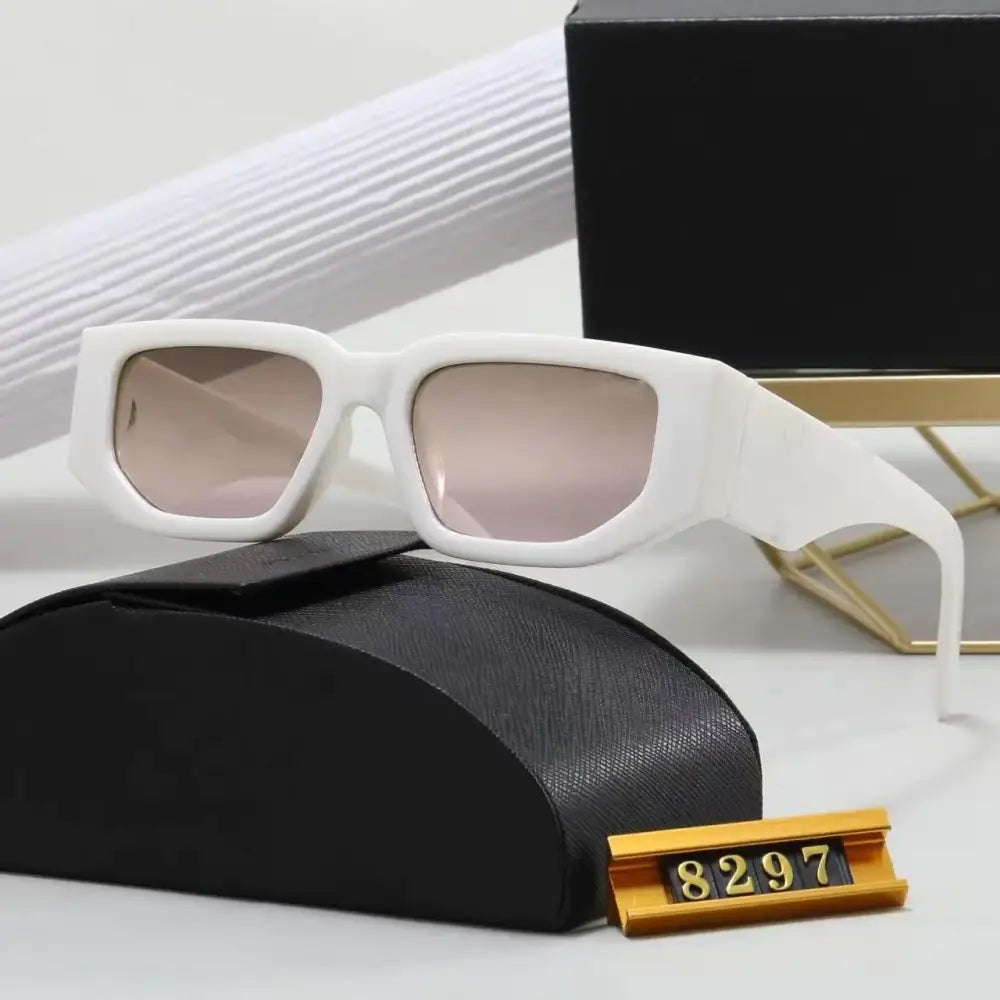White rectangular-framed sunglasses with light pink gradient lenses, displayed on a black textured case.