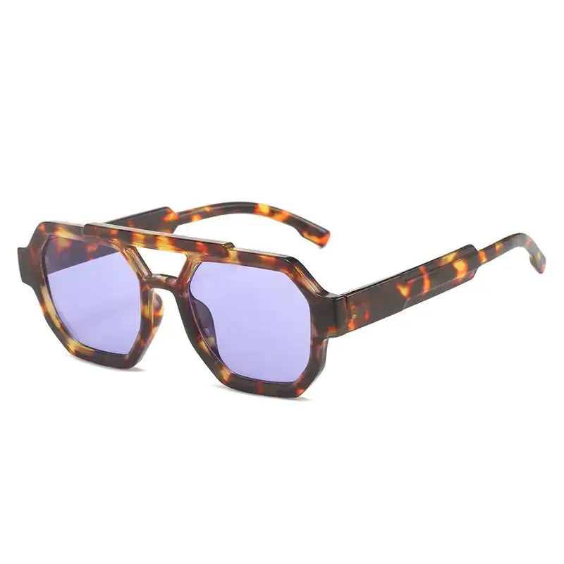 Tortoiseshell-patterned acetate sunglasses with geometric octagonal frames and purple-tinted lenses.