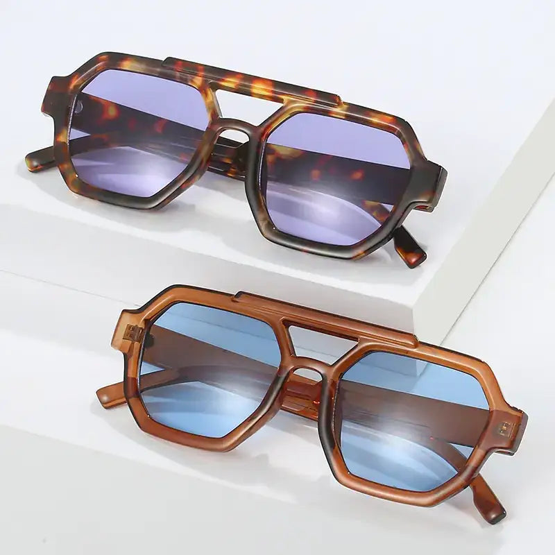 Tortoiseshell and translucent brown acetate sunglasses with geometric octagonal frames and gradient blue-purple lenses.