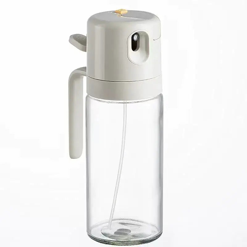 Clear glass spray bottle with a matte beige plastic pump and handle.