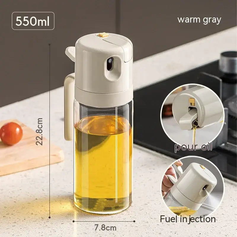 Warm gray plastic pour spout with handle and clear glass body containing golden oil, 550ml capacity