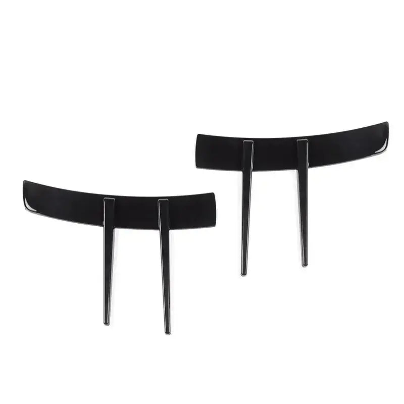 Black glossy plastic cake toppers with a curved top and two vertical prongs.