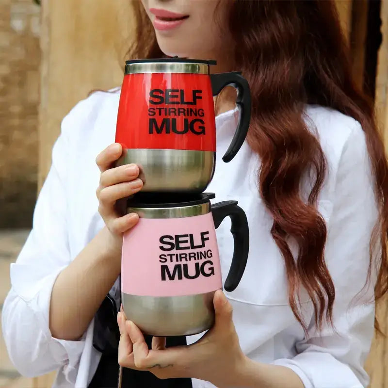 Red and pink self-stirring mugs with black handles and stainless steel accents