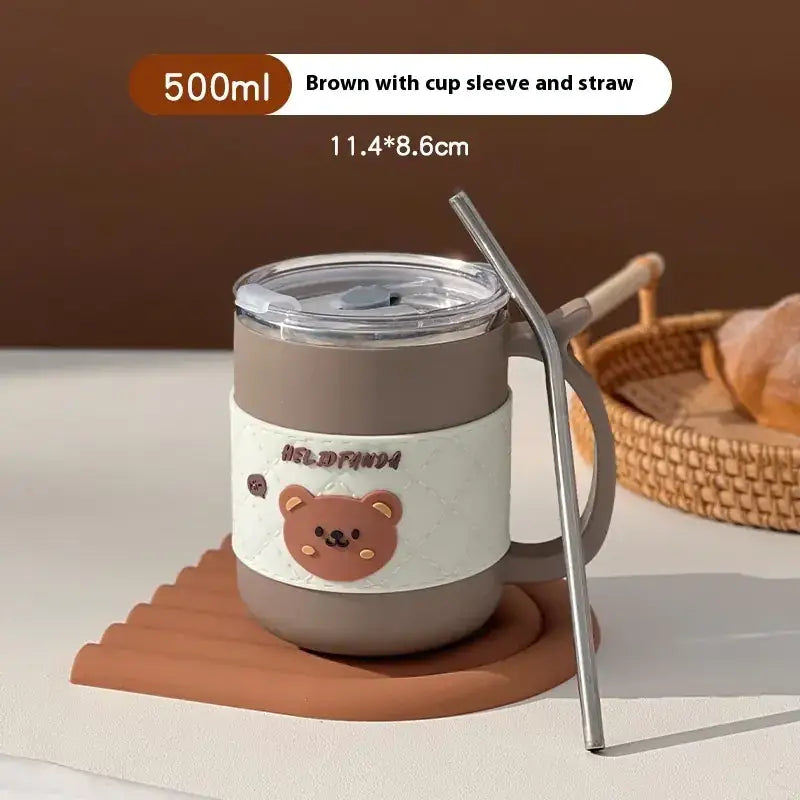 Brown 500ml insulated tumbler with a cute bear design on its white sleeve, featuring a clear lid and straw.