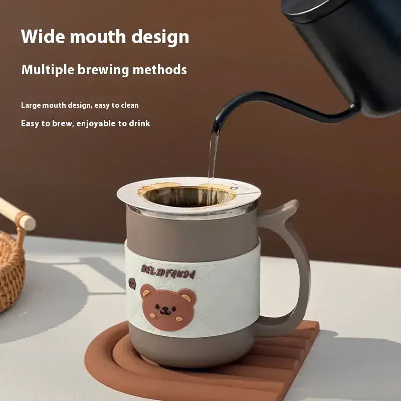 Cute gray and white ceramic coffee mug with a bear face decal, featuring a wide mouth design for easy brewing.