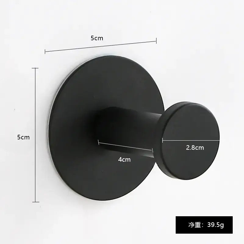 Black matte-finish wall-mounted hook with a circular base and rounded peg.