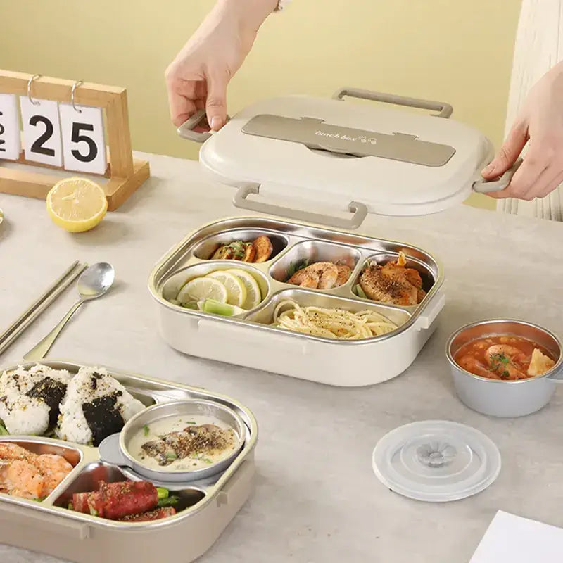 Beige and silver multi-compartment electric lunchbox with a lid featuring the brand name ’french & co.’